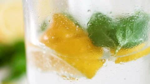 Closeup slow motion motion footage of pouring water and throwing ice cubes in Stock Footage