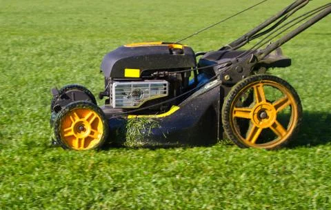 Closeup in Slow Motion of a Mower in Action Stock Photos