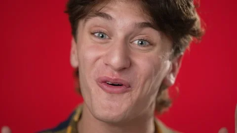 Closeup slow motion portrait of smiling happy young hipster man 20s isolated on Stock Footage 220731566