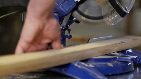 Closeup slow motion shot of carpenter sawing wooden planks. Cutting panel with Stock Footage 152348228