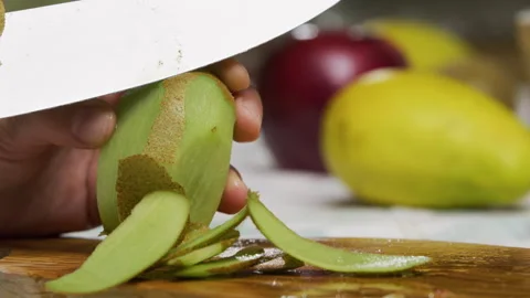 Closeup, slow motion shot of kiwi being shaved Stock Footage 341256910