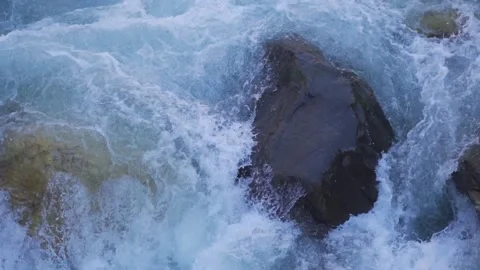 Closeup slow motion shot of a rock obstructing the flow of the river Parvati  Stock-Footage 200402043