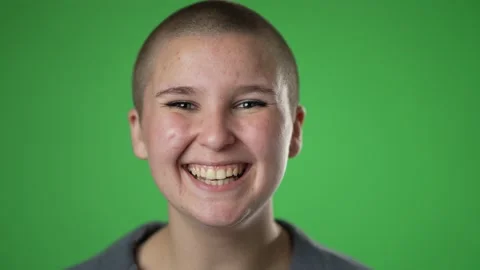 Closeup slow motion of smiling young gender fluid woman 20s years old posing Stock Footage 223354054