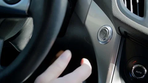 Closeup slow motion video of drivers hand pressing start engine button on car Stock Footage 83999582