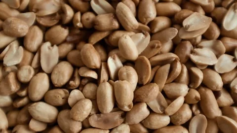 Closeup slow motion video of roasted clean peanuts healthy snack. Stock Footage 325345204