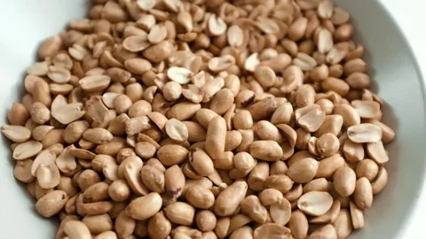 Closeup slow motion video of roasted clean peanuts healthy snack. Stock Footage 325345237