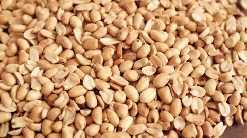 Closeup slow motion video of roasted clean peanuts healthy snack. Stock Footage 325345266