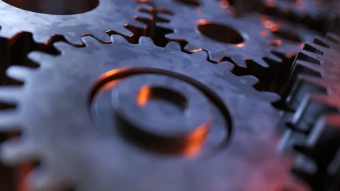 "Closeup on slowly rotating dark metallic gears. Clockwork machinery in motion." Stock Footage 98954013