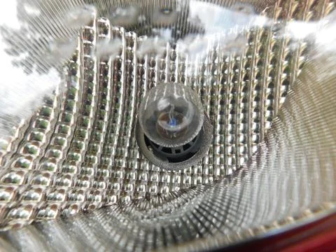 Closeup of small bulb fixed inside of the car light set Foto stock
