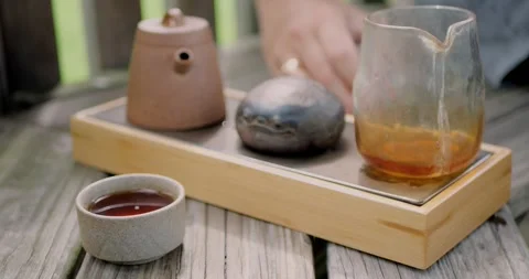 Closeup of small ceramic cup filled with freshly brewed Pu-erh... Stock Footage 316914568