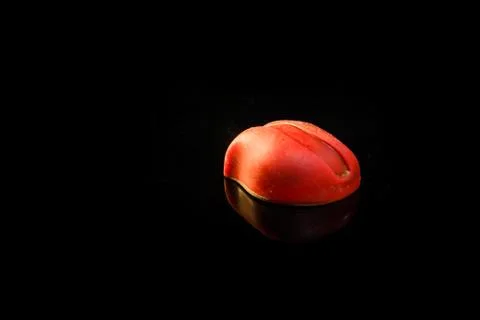 Closeup small red oval-shaped chocolate candy with reflection Stock-Fotos