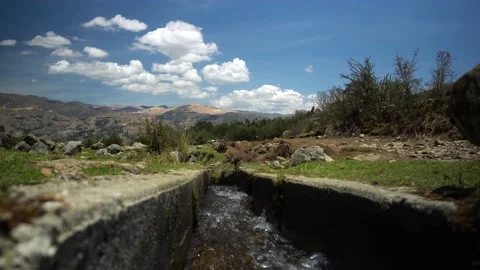 Closeup of a small river water channel coming from a lagoon in the Peruvian Video stock 164594746