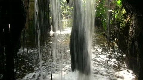 Closeup of a small waterfall from behind Stock Footage 365264