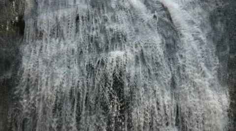 Closeup of a small waterfall flowing down rock wall Stock-Footage 365270