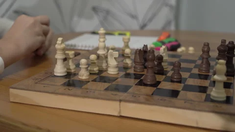 Closeup smart boy playing chess with his mother sitting at a table Stock Footage 259199324