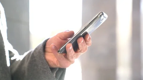Closeup of smartphone held by man's hand Stock Footage 72010581