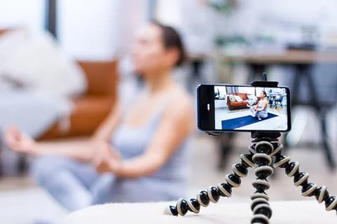 Closeup smartphone screen, process of live video recording. Young woman is sh Stock Photos