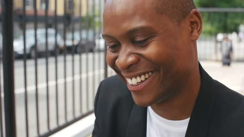 Closeup of Smiling Black Man in His Thirties Saying Hello and Waving at Camera Video stock 79208171