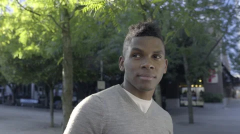 Closeup Of Smiling Man In A Park, He Walks, Camera Follows (Slow Motion) Stock Footage