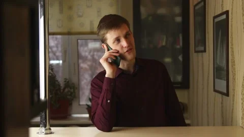 Closeup smiling man talking mobile phone in home. Businessman having phone call Stock Footage 148084572