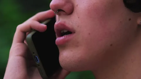 Closeup smiling man talking mobile phone outdoors. Close up of cheerful Stock Footage 243374668