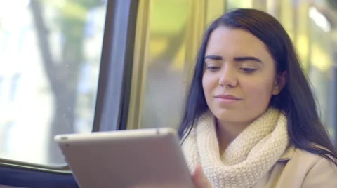 Closeup Of Smiling Mixed Race Young Woman Traveling By Train, Using Tablet Video stock 47418726
