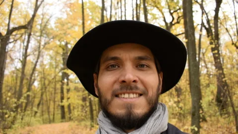 Closeup of smiling young man with beard looking at rotation camera in forest. Stock Footage 101636325