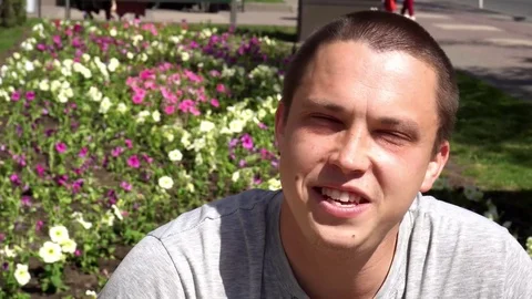 Closeup of smiling young man looking at camera who changes facial expressions Stock Footage 75209836