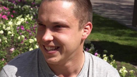 Closeup of smiling young man looking at camera who changes facial expressions Stock Footage 75209911