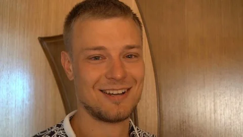Closeup of smiling young man looking at camera isolated on white background Stock Footage 79191842