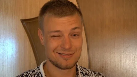 Closeup of smiling young man looking at camera isolated on white background Stock Footage 79191962