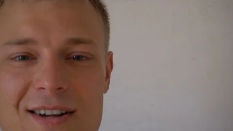 Closeup of smiling young man looking at camera isolated on white background Stock Footage 79193858