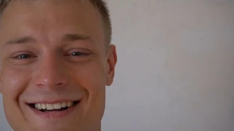 Closeup of smiling young man looking at camera isolated on white background Stock Footage 79193922