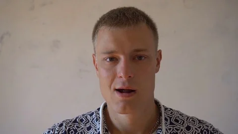 Closeup of smiling young man looking at camera isolated on white background Stock Footage 79194003