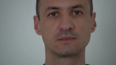 Closeup of smiling young man looking at camera isolated on white background Stock Footage 245305846