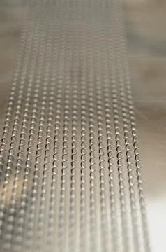 Closeup of snares on the backside of a snare drum. these are little metal spr Stock Photos