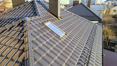 Closeup snow guard for safety in winter on house roof top covered with ceramic Stock Footage 167049032