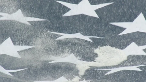 Closeup of snowfall bouncing on American flag Stock Footage 104770997