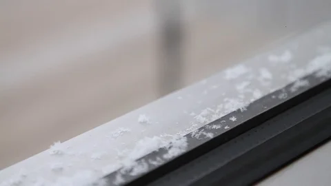 Closeup snowflakes falling on a windowsill Stock Footage 112635380