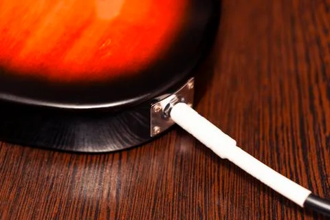 Closeup of a socket connecting cord. On the background of a wooden table. Stock Photos