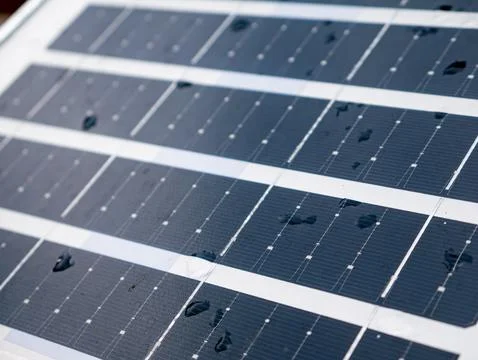 Closeup solar panel surface with water rain droplets showing photovoltaic c.. Stock Photos