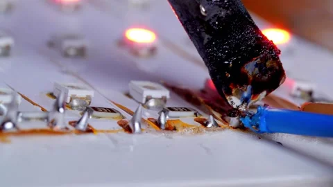 Closeup of Soldering Iron Broken Capacitor from Motherboard Video stock 337450196