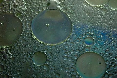 Closeup of solid surface with bubbly circles in dark gray color Stock Photos