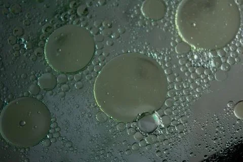 Closeup of solid surface with bubbly circles in dark gray color Stock Photos