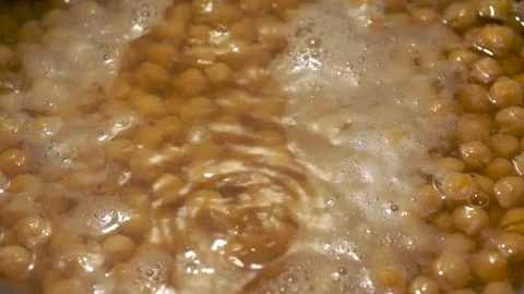Closeup of some chickpeas boiling in water Stock Footage 252399462