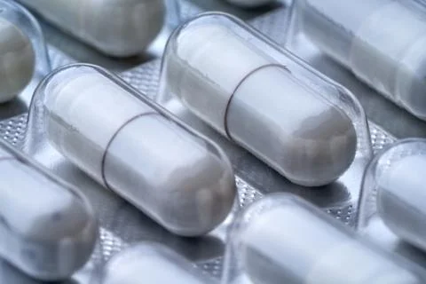 Closeup of some  gray pills in packaging. Stock Photos
