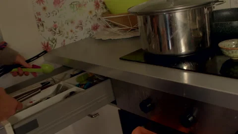 Closeup of someone choosing utensils from ceramic bowl on tidy countertop Stock Footage 325074886