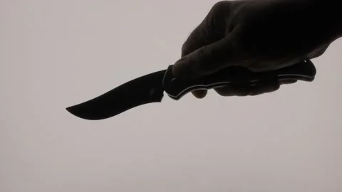 Closeup of someone wielding a knife with a sharp blade. Stock Footage 136571711