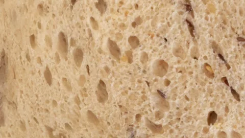 Closeup of sourdough bread texture rotating slowly showing porous structure and Stock Footage 313794570