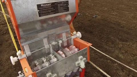 Closeup of sowing seeds with seed cum fertilizer drill machine Stock Footage 77652453